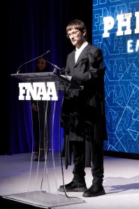 NEW YORK, NEW YORK - DECEMBER 04: Phileo Landowski speaks onstage during the Footwear News Achievement Awards (FNAAs) 2024 at Cipriani South Street on December 04, 2024 in New York City.  (Photo by Craig Barritt/Footwear News via Getty Images)