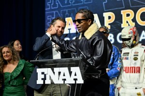 NEW YORK, NEW YORK - DECEMBER 04: Arne Freundt and A$AP Rocky speak onstage at the Footwear News Achievement Awards (FNAAs) 2024 at Cipriani South Street on December 04, 2024 in New York City. (Photo by Roy Rochlin/Footwear News via Getty Images)